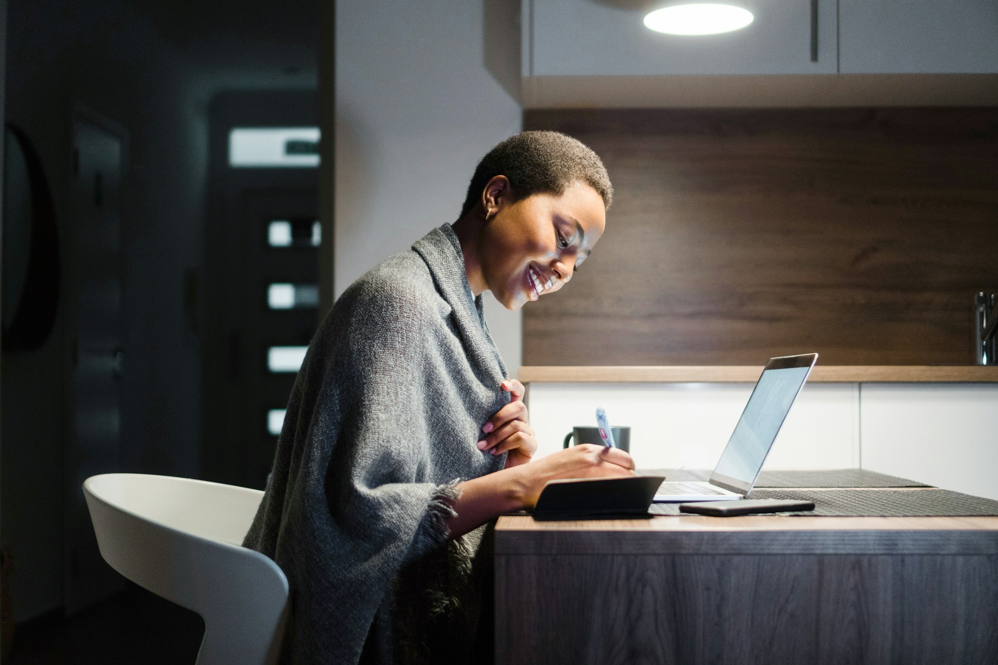 Young black woman finishing work at home