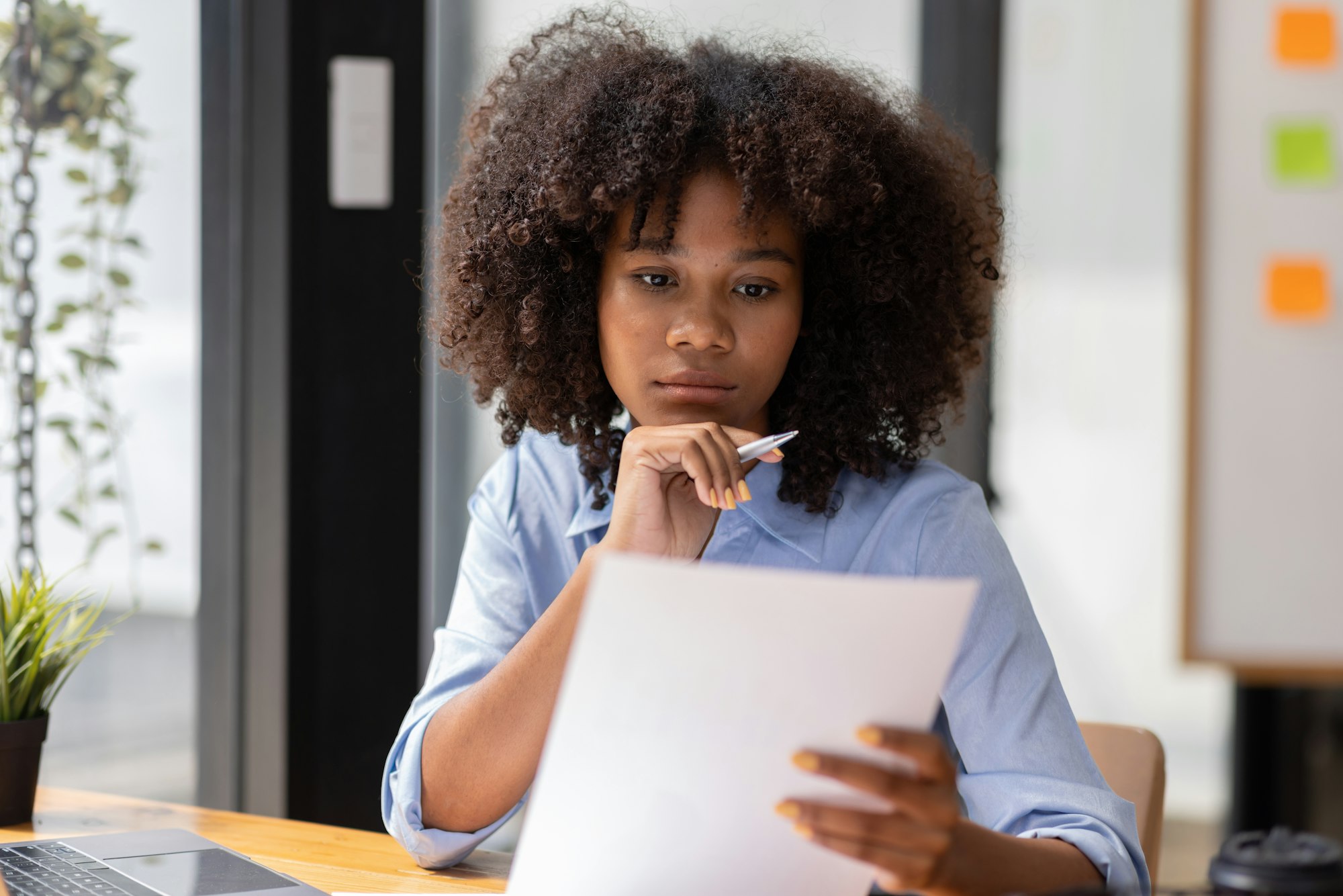 Accountant Young african businesswoman in afro hairstyle Using Calculator For documents Accounting